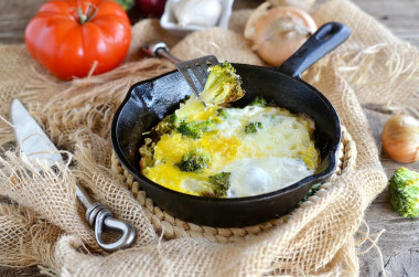 Broccoli with egg in a frying pan