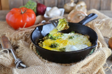 Broccoli with egg in a frying pan