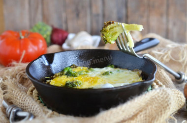 Broccoli with egg in a frying pan