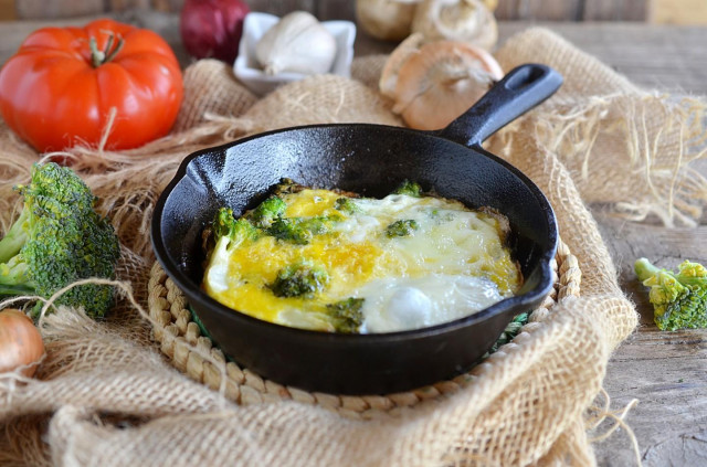 Broccoli with egg in a frying pan