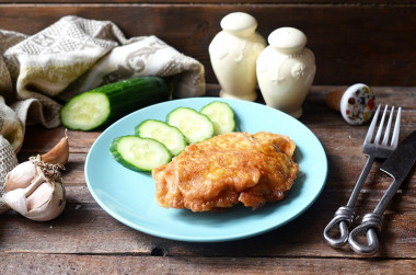 Chicken breast in batter in a frying pan