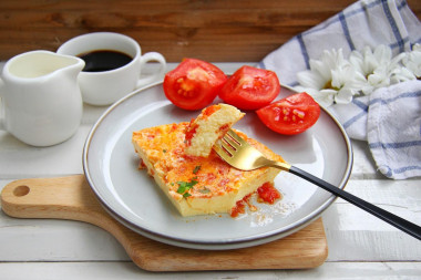 Omelet with tomatoes in a frying pan