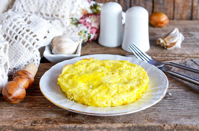 Omelet of eggs and milk plain in a frying pan