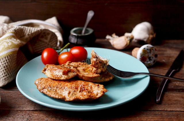 Juicy chicken breasts in a frying pan