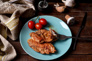 Juicy chicken breasts in a frying pan