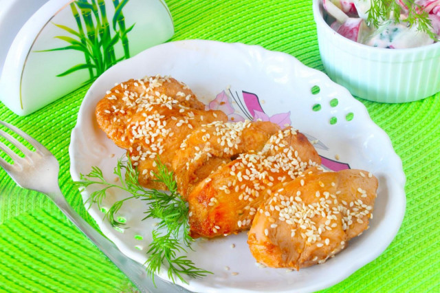 Chicken fillet in soy sauce in a frying pan