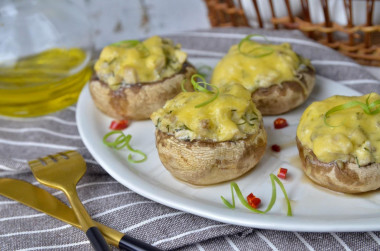 Mushrooms stuffed with chicken and cheese in the oven