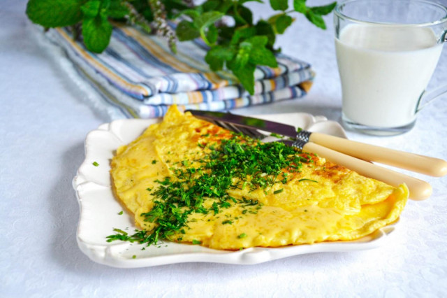 French omelet stuffed with cheese and herbs