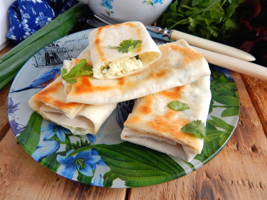 Pita bread envelopes in a frying pan