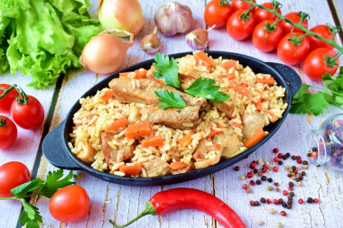 Crumbly pilaf with pork in a frying pan