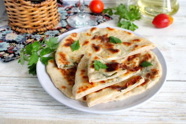 Tortillas with cottage cheese and herbs in a frying pan