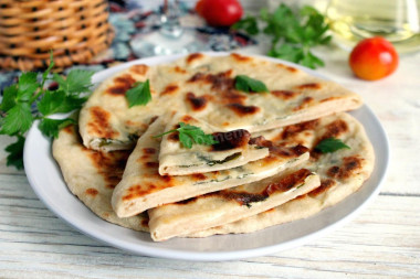 Tortillas with cottage cheese and herbs in a frying pan