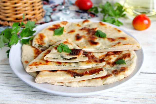 Tortillas with cottage cheese and herbs in a frying pan