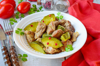 Pork with zucchini stewed in a frying pan