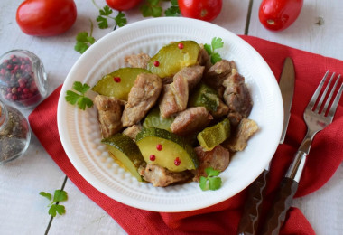 Pork with zucchini stewed in a frying pan