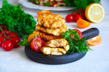 Cutlets in pieces from chicken fillet with mayonnaise in a frying pan