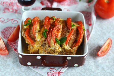 Pork accordion in the oven in foil with tomatoes