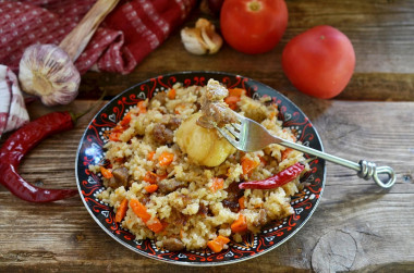 Pilaf in a cauldron on a fire of mutton