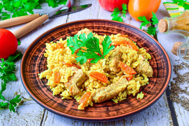 Pilaf with turkey in a frying pan