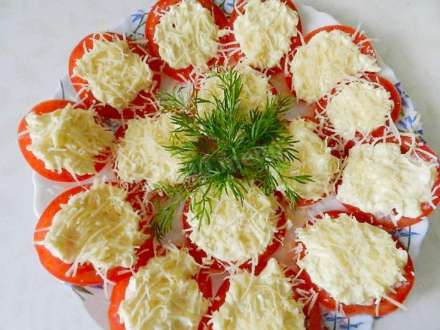 Tomato snack with cheese and garlic filling