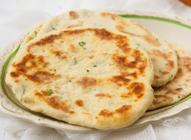 Tortillas with greens on kefir in a frying pan