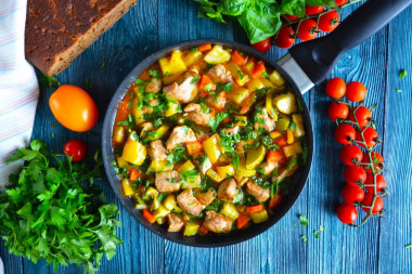 Pork stewed with vegetables in a frying pan