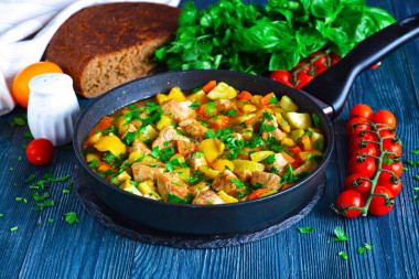 Pork stewed with vegetables in a frying pan