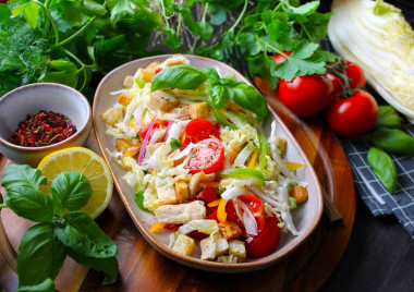 Peking cabbage salad with chicken croutons and tomatoes