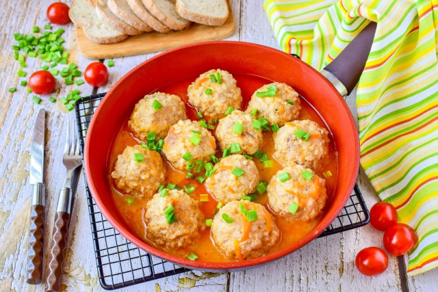 Minced meat meatballs with rice in a frying pan