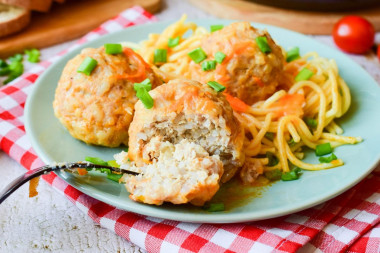 Minced meat meatballs with rice in a frying pan