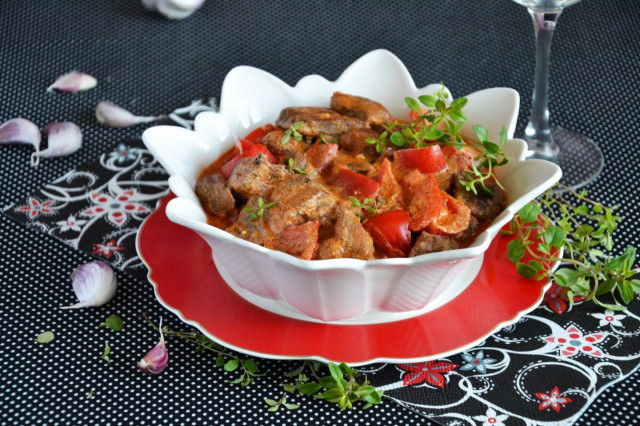 Meat in sauce in a frying pan with vegetables