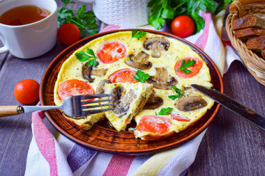 Omelet with mushrooms and cheese in a frying pan for breakfast