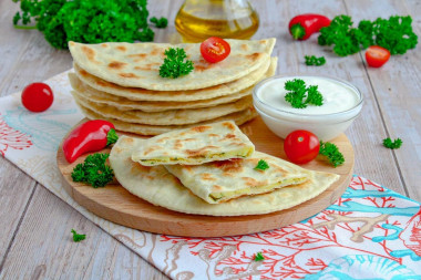 Thin tortillas in a frying pan made of dough with filling