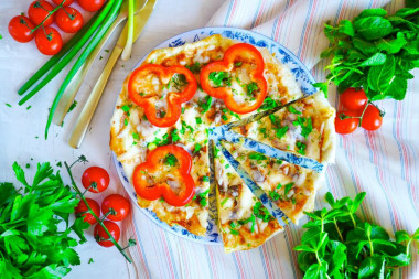 Fried eggs in pita bread in a frying pan with cheese