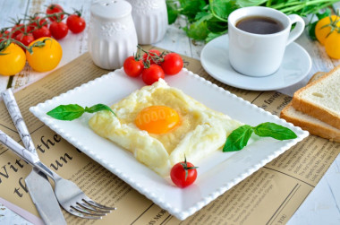 Breakfast of eggs and cheese in a frying pan