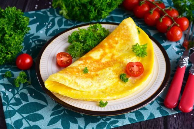 Classic omelet with milk in a frying pan