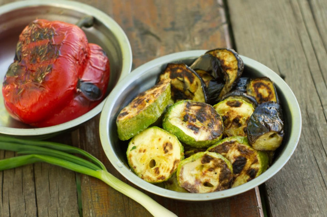 Vegetables on a grill on coals