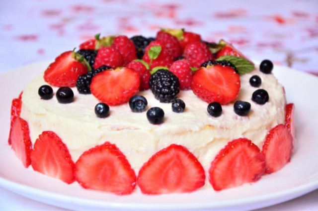 Pancake cake with cottage cheese and berries in a frying pan