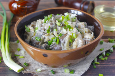 Oyster mushrooms in sour cream in a frying pan