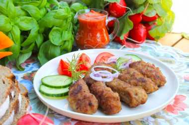 Chevapchichi sausages in a frying pan