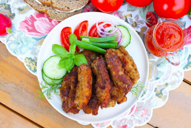 Chevapchichi sausages in a frying pan