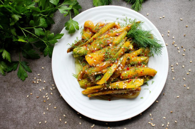 Zucchini with soy sauce and garlic in a frying pan