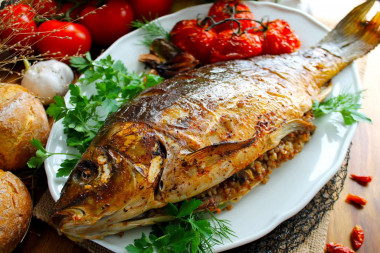 Whole stuffed carp baked in the oven