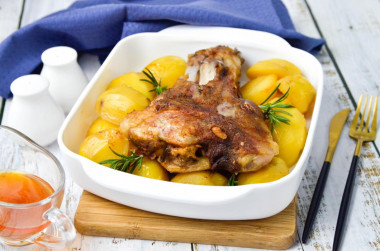 Pork knuckle baked with potatoes in the oven