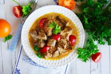 Liver with carrots, onions and mayonnaise in a frying pan