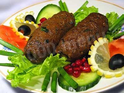 Minced meat shish kebab in a frying pan