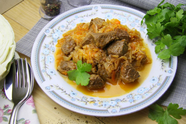 Stewed cabbage with meat in a saucepan