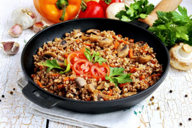 Mushrooms with buckwheat in a frying pan