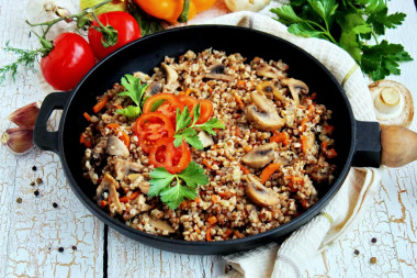 Mushrooms with buckwheat in a frying pan