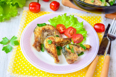 Mackerel in a frying pan with onions